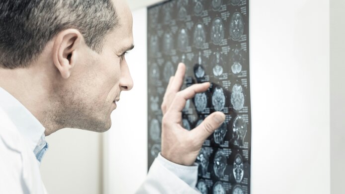 A doctor looking at an X-ray image